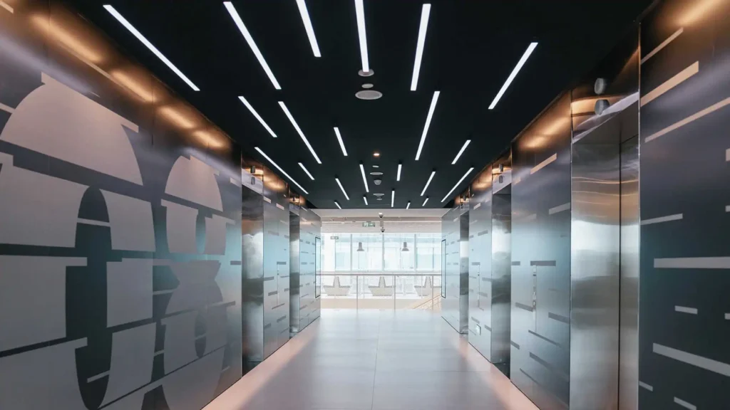 Modern office hallway illuminated by linear LED lights