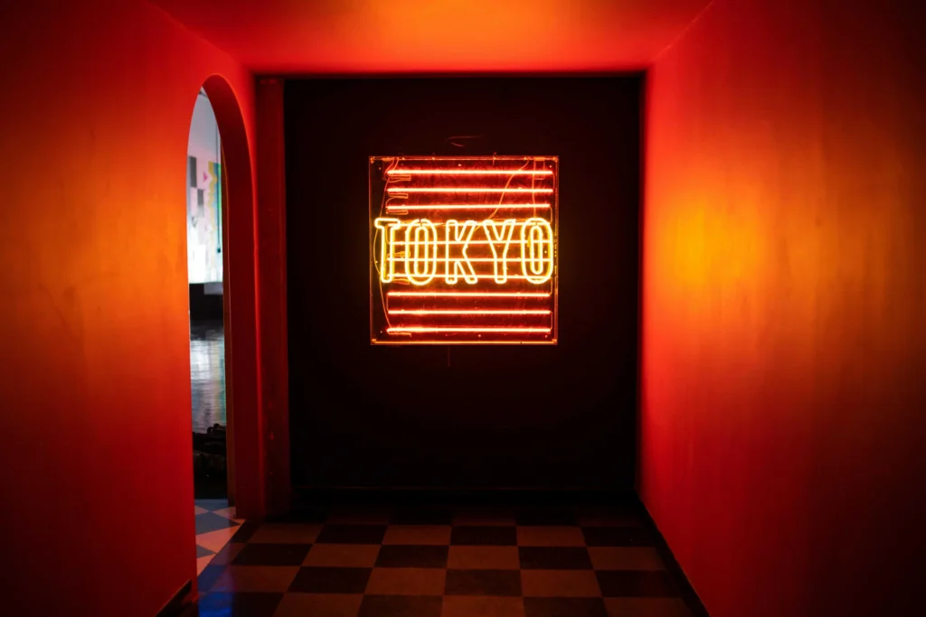 Vibrant neon LED sign in a red-lit room