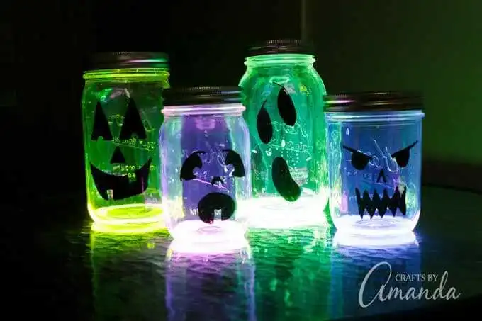 DIY Halloween mason jar lights glowing with colorful LED strips for spooky indoor fun