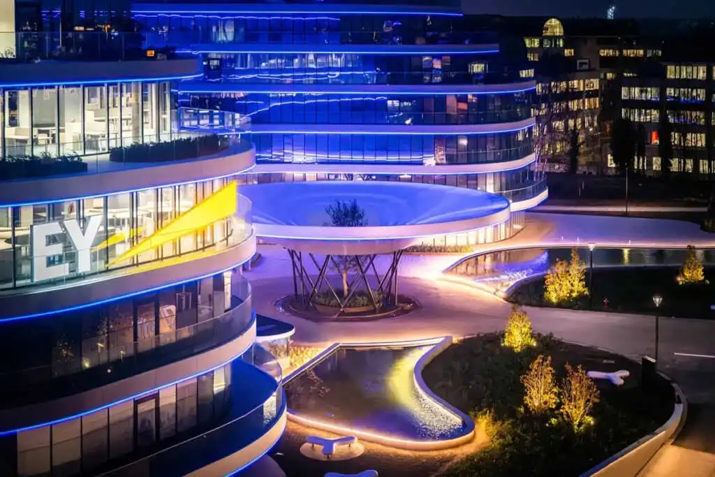 Embedded LED strip creating seamless invisible glow line on modern building facade for 2026 architectural trends