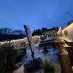 Outdoor perimeter LED strip lighting continuous run on modern building at night