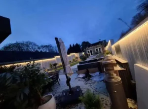 Outdoor perimeter LED strip lighting continuous run on modern building at night