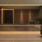 High-uniformity warm white LED backlight strips used in luxury hotel lobby design, installed in ceiling, reception counter and floor for 5-star hospitality lighting projects