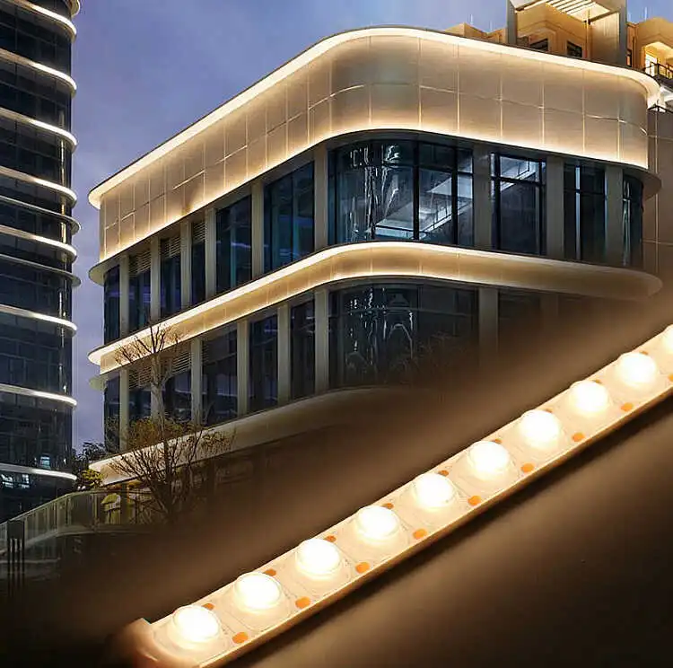 Warm white LED strip lights installed on a curved modern commercial building facade at night, with a close-up of the LED strip PCB in the foreground showing individual LED chips for outdoor architectural wall wash lighting