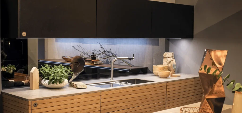 Dotless LED strip for modern kitchen installed under dark cabinets, showcasing seamless under cabinet lighting with no visible dots, ideal for minimalist kitchen cabinet LED strip lights