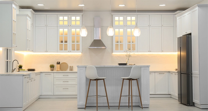 Modern kitchen featuring seamless under-cabinet LED strip lighting illuminating quartz countertops