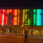 College Football Hall of Fame building facade with large-scale RGB LED architectural contour lighting installation — real-world example of IP67 outdoor silicone neon flex used in landmark commercial building outline lighting projects