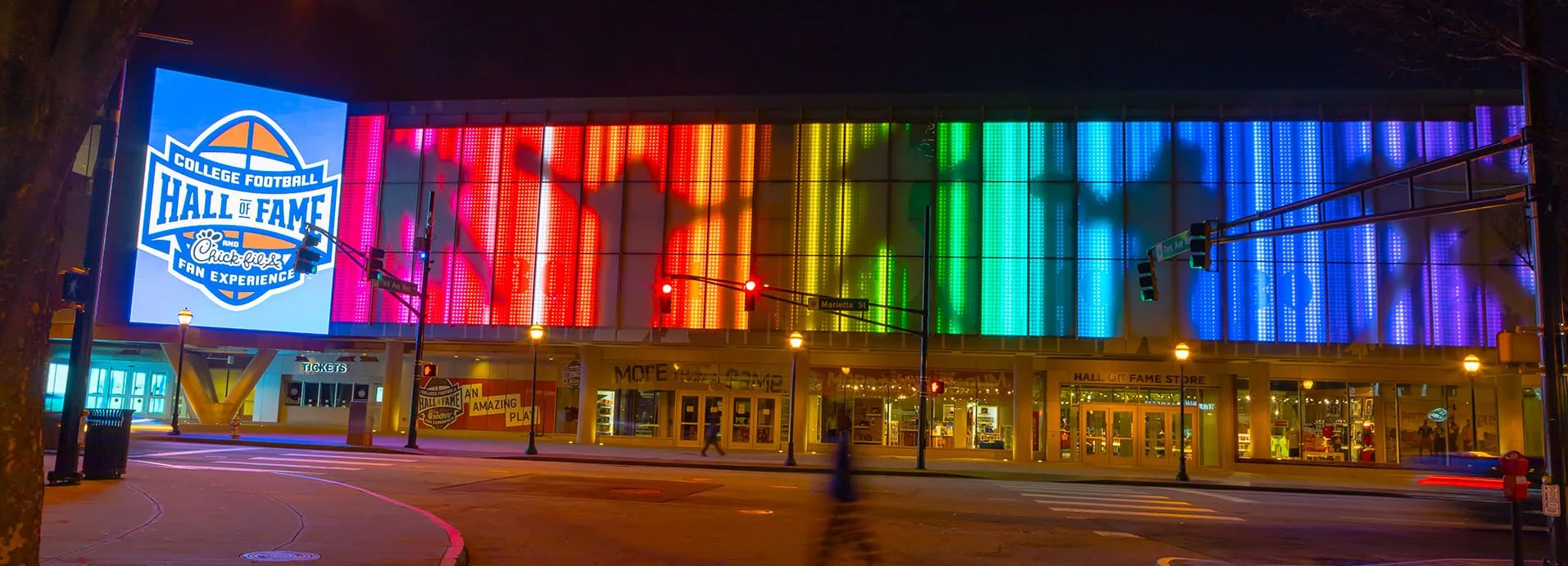 College Football Hall of Fame building facade with large-scale RGB LED architectural contour lighting installation — real-world example of IP67 outdoor silicone neon flex used in landmark commercial building outline lighting projects