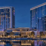 DMX LED neon flex facade lighting on a modern hotel building with RGBW vertical lines for programmable architectural effects.