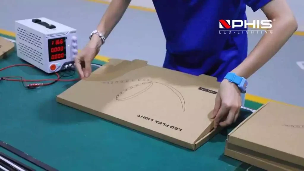 factory-electrical-quality-testing-addressable-led-neon-flex-packaging » Custom LED Strip Lights Manufacturer | Silicone Neon Flex Supplier China NPHIS factory staff performing power-on quality inspection and carton packaging for finished addressable LED neon flex pixel lighting products