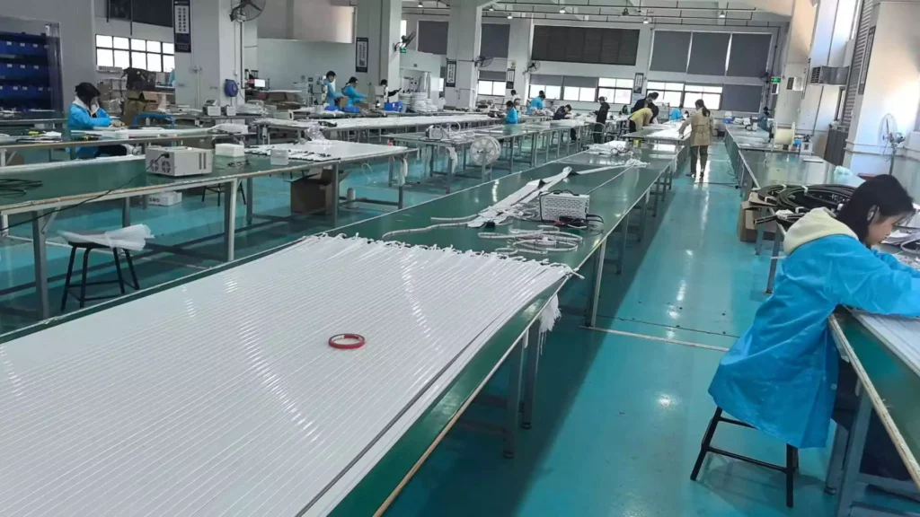 NPHIS LED factory production line where workers assemble and test silicone LED neon flex strips before shipping for commercial installation projects